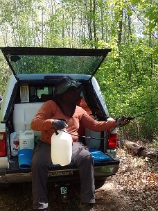 Lenise using the sprayer from the Ranger 2016 - Lenise using the hand sprayer from the back of the truck